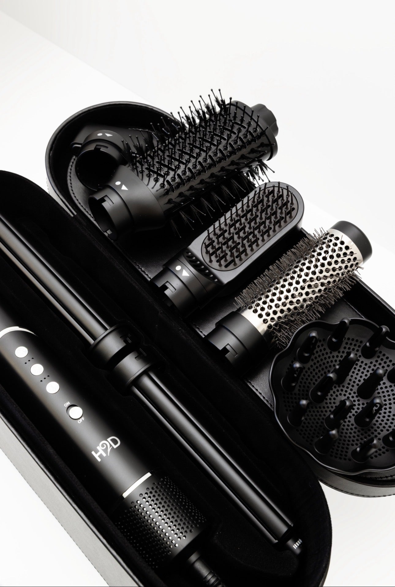 H2D 7-in-1 Ultra Styler Matte Black hair styling tool with attachments arranged in travel case