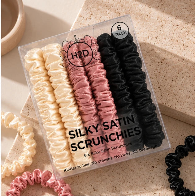 Silky Satin Scrunchies 6 pack styled on a stone surface