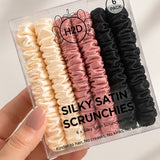 Hand holding the Silky Satin Scrunchies 6 pack